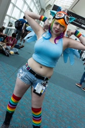 Size: 600x900 | Tagged: safe, artist:geekeryandsuch, imported from derpibooru, rainbow dash, human, belly button, big breasts, breasts, busty rainbow dash, cosplay, flexing, irl, irl human, midriff, photo, rainboob dashie ali, san diego comic con