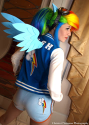 Size: 1462x2048 | Tagged: safe, artist:scruffyrebel, imported from derpibooru, rainbow dash, human, 2012, ass, butt, clothes, convention, cosplay, female, goggles, irl, irl human, jacket, katsucon, katsucon 2012, photo, print clothing, shorts, solo, varsity jacket