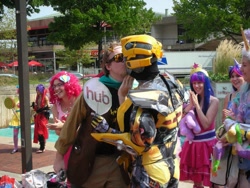 Size: 960x720 | Tagged: safe, imported from derpibooru, discord, pinkie pie, twilight sparkle, human, bronycon, bumblebee, bumblebee (transformers), bumblecord, cosplay, crossover shipping, hub logo, hubble, irl, irl human, kissing, photo, shipping, the hub, transformers, wat