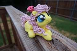 Size: 1024x680 | Tagged: safe, artist:sculpedetails, imported from derpibooru, fluttershy, figure, flower, flower in hair, folded wings, irl, looking up, lying, photo, rose, sculpture, solo
