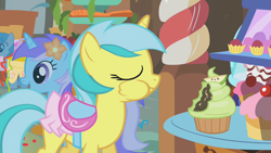 Size: 1280x720 | Tagged: safe, imported from derpibooru, screencap, diamond mint, lemony gem, lightning bolt, white lightning, pegasus, pony, unicorn, call of the cutie, season 1, background pony, clothes, cupcake, eyes closed, female, flower, flower in hair, food, mare, puffy cheeks, saddle, skirt, tack