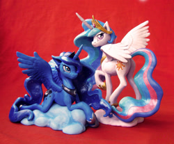 Size: 2552x2112 | Tagged: safe, artist:alexcroft1991, imported from derpibooru, princess celestia, princess luna, alicorn, pony, butt, cloud, craft, female, looking back, looking up, mare, plot, prone, raised hoof, sculpture, smiling, spread wings, traditional art