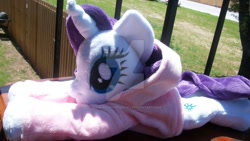 Size: 1024x576 | Tagged: safe, artist:siamchuchusplushies, imported from derpibooru, rarity, beanie (plushie), clothes, hoodie, irl, photo, plushie, prone, solo, watermark