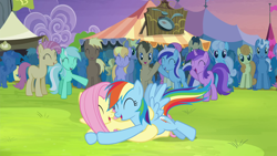 Size: 1920x1080 | Tagged: safe, imported from derpibooru, screencap, fluttershy, rainbow dash, trade ya, cheering, crowd, glomp, hug, lying down, lying on top of someone, on back