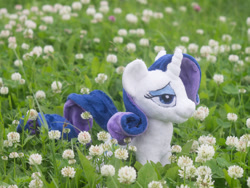 Size: 1000x750 | Tagged: safe, artist:valmiiki, imported from derpibooru, rarity, bedroom eyes, clover, dat face, doll, flower, garden, irl, nature, outdoors, photo, plushie, solo, toy