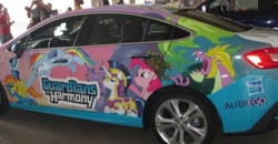 Size: 739x383 | Tagged: safe, imported from derpibooru, pinkie pie, rainbow dash, shining armor, soarin', spike, spitfire, pony, boston comic con, car, guardians of harmony, irl, itasha, photo, spikezilla