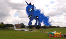 Size: 1024x606 | Tagged: safe, artist:theotterpony, imported from derpibooru, princess luna, alicorn, human, pony, bouncy castle, female, fountain, giant pony, irl, irl human, lidded eyes, macro, mare, mega luna, park, photo, ponies in real life, smiling