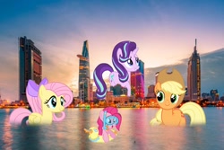 Size: 1800x1200 | Tagged: safe, imported from derpibooru, applejack, fluttershy, pinkie pie, starlight glimmer, pony, bitexco financial tower, flutterduck, giant pony, giant starlight glimmer, ho chi minh city, irl, macro, photo, ponies in real life, swimming, vietnam, water