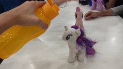 Size: 4128x2322 | Tagged: safe, imported from derpibooru, photographer:horsesplease, pinkie pie, rarity, twilight sparkle, human, bottle, doll, hand, irl, irl human, malaysia, photo, this will not end well, toy, water