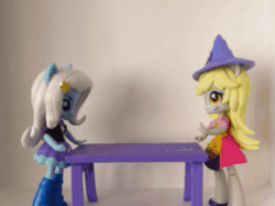 Size: 559x419 | Tagged: safe, artist:whatthehell!?, edit, imported from derpibooru, derpy hooves, trixie, equestria girls, animated, boots, clothes, doll, equestria girls minis, hat, irl, photo, shoes, skirt, table, toy