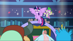 Size: 1669x941 | Tagged: safe, imported from derpibooru, screencap, gallus, ocellus, spike, twilight sparkle, yona, alicorn, dragon, pony, a matter of principals, classroom, duo focus, female, flying, happy, hooves on hips, male, mare, school of friendship, smiling, twilight sparkle (alicorn), winged spike, wings