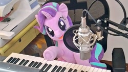 Size: 1024x577 | Tagged: safe, artist:nekokevin, imported from derpibooru, starlight glimmer, pony, unicorn, series:nekokevin's glimmy, chair, female, irl, keyboard, looking at you, mare, microphone, musical instrument, open mouth, photo, plushie, sewing machine, sitting, smiling, solo, underhoof