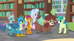 Size: 1280x720 | Tagged: safe, imported from derpibooru, screencap, gallus, ocellus, sandbar, silverstream, smolder, yona, changedling, changeling, classical hippogriff, dragon, earth pony, griffon, hippogriff, pony, yak, what lies beneath, bookshelf, bow, cloven hooves, colored hooves, cutie mark, dragoness, female, globe, hair bow, jewelry, library, male, monkey swings, necklace, student six, teenager