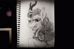 Size: 4288x2848 | Tagged: safe, artist:calveen, imported from derpibooru, autumn blaze, kirin, sounds of silence, fangs, female, horn, looking at you, monochrome, open mouth, pencil drawing, photo, raised hoof, sketch, sketchbook, smiling, solo, traditional art
