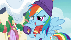 Size: 1280x720 | Tagged: safe, imported from derpibooru, screencap, rainbow dash, pegasus, pony, best gift ever, clothes, female, hat, mare, raised hoof, scarf, snow, solo