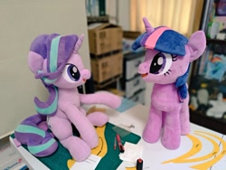 Size: 1024x768 | Tagged: safe, artist:nekokevin, imported from derpibooru, starlight glimmer, twilight sparkle, pony, unicorn, series:nekokevin's glimmy, desk, duo, female, irl, looking at each other, mare, open mouth, photo, plushie, raised hoof, sitting, smiling, unicorn twilight