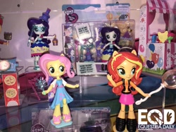 Size: 1210x907 | Tagged: safe, imported from derpibooru, screencap, fluttershy, rarity, sunset shimmer, equestria girls, equestria girls series, clothes, doll, dress, equestria girls logo, equestria girls minis, female, irl, jacket, photo, sandals, shoes, skirt, toy, toy fair, toy fair 2018