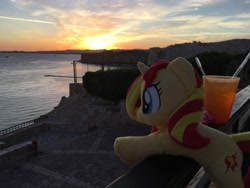 Size: 4032x3024 | Tagged: safe, artist:epicrainbowcrafts, imported from derpibooru, sunset shimmer, unicorn, drink, glass, irl, ocean, photo, plushie, pun, sunset, sunshine shimmer, visual pun