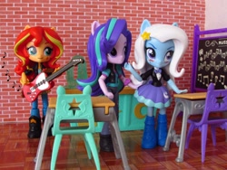 Size: 1600x1200 | Tagged: safe, artist:whatthehell!?, imported from derpibooru, starlight glimmer, sunset shimmer, trixie, equestria girls, boots, chair, chalkboard, classroom, clothes, desk, doll, equestria girls minis, gem, guitar, irl, jacket, photo, school, shoes, skirt, toy