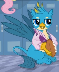 Size: 599x731 | Tagged: safe, imported from derpibooru, screencap, fluttershy, gallus, griffon, season 8, american football, claws, clothes, cropped, jacket, letterman jacket, male, paws, solo focus, sports, varsity jacket, wings