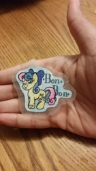 Size: 3264x1836 | Tagged: safe, artist:binkyt11, derpibooru exclusive, imported from derpibooru, bon bon, sweetie drops, earth pony, pony, :p, bow, female, hair bow, hand, looking at you, mare, one eye closed, silly, solo, sticker, tongue out, traditional art, wink