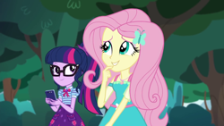 Size: 1280x720 | Tagged: safe, imported from derpibooru, screencap, fluttershy, sci-twi, twilight sparkle, equestria girls, equestria girls series, text support, female, geode of fauna, geode of telekinesis, glasses, hairpin, phone, ponytail, smiling, text support: fluttershy