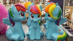 Size: 960x540 | Tagged: safe, imported from derpibooru, rainbow dash, ceramic, dashstorm, doll, irl, multeity, my little pony logo, photo, sitting, toy, triality, trio, triple rainbow, walmart
