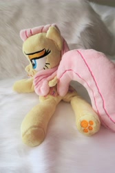 Size: 3648x5472 | Tagged: safe, artist:kazzysart, imported from derpibooru, fluttershy, pegasus, pony, beanie (plushie), female, folded wings, irl, lidded eyes, mare, photo, plushie, prone, solo, underhoof, wings