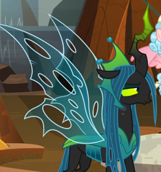 Size: 514x550 | Tagged: safe, imported from derpibooru, screencap, cozy glow, queen chrysalis, changeling, changeling queen, the ending of the end, annoyed, cropped, crown, evil lair, female, filly, former queen chrysalis, grogar's lair, horn, jewelry, lair, queen chrysalis is not amused, regalia, solo focus, spread wings, ultimate chrysalis, unamused, wings