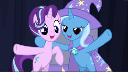 Size: 1667x939 | Tagged: safe, imported from derpibooru, screencap, starlight glimmer, trixie, pony, unicorn, road to friendship, bipedal, cape, clothes, cropped, cute, duo, female, glimmerbetes, hat, hind legs, hoof around neck, lidded eyes, mare, open mouth, smiling, trixie's cape, trixie's hat, waving