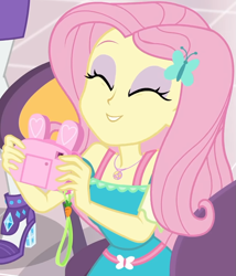 Size: 855x1000 | Tagged: safe, imported from derpibooru, screencap, fluttershy, rarity, equestria girls, equestria girls series, holidays unwrapped, spoiler:eqg series (season 2), bunny ears, camera, canterlot mall, chair, clothes, cropped, cute, dashing through the mall, dress, eyes closed, female, flower, fluttershy boho dress, geode of fauna, gift giving, hairclip, happy, jewelry, legs, magical geodes, mall, necklace, present, shyabetes, sitting, skirt, smiling, table, waistband