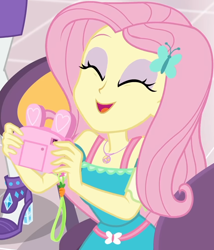 Size: 860x1004 | Tagged: safe, imported from derpibooru, screencap, fluttershy, rarity, equestria girls, equestria girls series, holidays unwrapped, spoiler:eqg series (season 2), bunny ears, camera, canterlot mall, chair, clothes, cropped, cute, dashing through the mall, dress, eyes closed, female, flower, geode of fauna, gift giving, hairclip, happy, jewelry, legs, magical geodes, mall, necklace, present, shyabetes, sitting, skirt, smiling, table, waistband