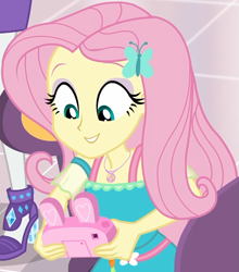 Size: 853x970 | Tagged: safe, imported from derpibooru, screencap, fluttershy, rarity, equestria girls, equestria girls series, holidays unwrapped, spoiler:eqg series (season 2), bunny ears, camera, canterlot mall, chair, clothes, cropped, cute, dashing through the mall, dress, female, flower, fluttershy boho dress, geode of fauna, gift giving, hairclip, happy, jewelry, looking down, magical geodes, mall, necklace, shyabetes, sitting, smiling, table, waistband