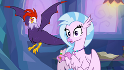 Size: 1920x1080 | Tagged: safe, imported from derpibooru, screencap, edith (cockatrice), silverstream, classical hippogriff, cockatrice, hippogriff, student counsel, duo, edith, female, open beak, pencil, red eyes, spread wings, treehouse of harmony, wings