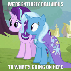 Size: 676x676 | Tagged: safe, edit, edited screencap, imported from derpibooru, screencap, starlight glimmer, trixie, pony, unicorn, road to friendship, animated, blinking, cape, caption, clothes, female, frown, image macro, looking at something, mare, oblivious, text, trixie's cape, wat, wide eyes