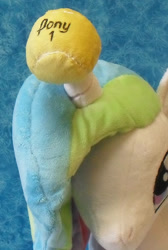 Size: 733x1091 | Tagged: safe, artist:bluedragonflyplush, imported from derpibooru, princess celestia, alicorn, pony, ball, female, folded wings, hilarious in hindsight, horn, horn guard, horn impalement, horn problems, hornball, irl, mare, photo, plushie, prone, solo, tennis ball, unicorn problems, wings, young celestia
