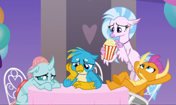 Size: 1606x957 | Tagged: safe, imported from derpibooru, screencap, gallus, ocellus, silverstream, smolder, changedling, changeling, classical hippogriff, dragon, griffon, hippogriff, she's all yak, arm behind head, chair, claws, cropped, crossed legs, curved horn, cute, diaocelles, diastreamies, dragoness, feet on table, female, flapping, flippance, flying, folded wings, food, gallabetes, group, guilty, hand on cheek, horn, horns, jewelry, looking down, looking up, necklace, pearl necklace, popcorn, sad, sad face, sitting, smolderbetes, spread wings, sulking, table, talons, teenaged dragon, teenager, toes, underfoot, wings