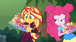 Size: 1914x1080 | Tagged: safe, imported from derpibooru, screencap, pinkie pie, sunset shimmer, equestria girls, equestria girls series, wake up!, spoiler:choose your own ending (season 2), spoiler:eqg series (season 2), bread, cake, candy, croissant, donut, duo, duo female, female, food, frosting, imminent consumption, imminent stuffing, jelly beans, junk food, music festival outfit, outdoors, pastries, pastry, this will end in diabetes, this will end in tummy aches, this will not end well, waffle, wake up!: pinkie pie