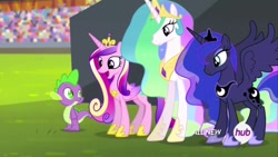 Size: 1280x720 | Tagged: safe, imported from derpibooru, screencap, princess cadance, princess celestia, princess luna, spike, alicorn, dragon, pony, equestria games (episode), all new, crown, crystal stadium, female, happy, height difference, hub logo, jewelry, male, mare, open mouth, regalia, slim, spread wings, text, thin, wings