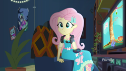 Size: 1600x900 | Tagged: safe, imported from derpibooru, screencap, fluttershy, costume conundrum, equestria girls, equestria girls series, spoiler:choose your own ending (season 2), spoiler:eqg series (season 2), controller, cute, female, gamershy, geode of fauna, headphones, magical geodes, poster, potted plant, shyabetes, sitting, sunset's apartment, television, video game