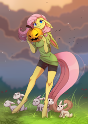 Size: 1897x2676 | Tagged: safe, artist:1an1, imported from derpibooru, fluttershy, anthro, bird, pegasus, rabbit, unguligrade anthro, androgynous, animal, beautiful, blue eyes, blushing, bunny ears, clothes, cloud, compression shorts, cute, evening, female, floppy ears, grass, halloween, holiday, hoodie, jack-o-lantern, looking at you, pink mane, pink tail, pumpkin, shorts, shyabetes, standing, sweater, wavy mouth, yellow fur