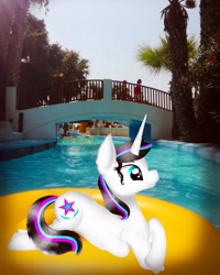 Size: 1000x1250 | Tagged: safe, artist:rxndxm.artist, imported from derpibooru, oc, oc:shooting star, pony, unicorn, female, floaty, horn, irl, lying down, mare, outdoors, photo, ponies in real life, prone, solo, swimming pool, unicorn oc