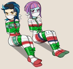 Size: 819x778 | Tagged: safe, artist:nivek15, edit, editor:thomasfan45, imported from derpibooru, indigo zap, sunny flare, human, equestria girls, annoyed, arm behind back, bondage, bound and gagged, bow, christmas, cloth gag, clothes, cropped, crystal prep shadowbolts, cute, duo, female, femsub, footed sleeper, footie pajamas, gag, gift wrapped, help us, holiday, indigosub, onesie, otn gag, over the nose gag, pajamas, ribbon, sitting, sleep mask, sleepwear, subflare, submissive, tied up