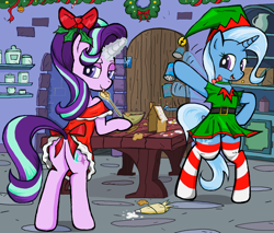 Size: 1670x1420 | Tagged: safe, artist:sallycars, imported from derpibooru, starlight glimmer, trixie, pony, unicorn, baking, bipedal, butt, christmas, clothes, cooking, dress, female, festive, gingerbread house, glowing horn, holiday, hoof hold, horn, icing bag, looking at you, looking back, looking back at you, magic, mare, ms paint, plot, socks, striped socks, telekinesis, tongue out, waving