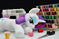 Size: 4096x2730 | Tagged: safe, artist:azurier, artist:shunnkai, imported from derpibooru, rarity, pony, unicorn, fabric, female, irl, lidded eyes, looking at you, lying down, mare, photo, plushie, scissors, sewing machine, smiling, solo