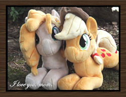 Size: 1650x1275 | Tagged: safe, artist:peruserofpieces, imported from derpibooru, applejack, pear butter, earth pony, beanie (plushie), female, irl, looking at you, mare, mother and child, mother and daughter, photo, plushie, prone