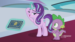 Size: 1280x720 | Tagged: safe, imported from derpibooru, screencap, spike, starlight glimmer, dragon, pony, unicorn, memories and more, spoiler:memories and more, spoiler:mlp friendship is forever, 9now, bedroom eyes, book, crossed arms, duo, levitation, looking at each other, magic, magic aura, scrapbook, telekinesis, winged spike, wings