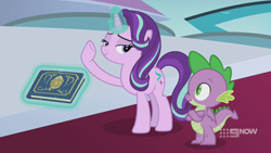 Size: 1280x720 | Tagged: safe, imported from derpibooru, screencap, spike, starlight glimmer, dragon, pony, unicorn, memories and more, spoiler:memories and more, spoiler:mlp friendship is forever, 9now, bedroom eyes, book, crossed arms, duo, levitation, looking at each other, magic, magic aura, scrapbook, telekinesis, winged spike, wings