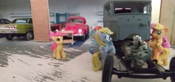 Size: 3264x1546 | Tagged: safe, imported from derpibooru, apple bloom, applejack, derpy hooves, pinkie pie, rainbow dash, blind bag, cart, chevrolet impala, engine, everfree customs, female, garage, irl, mechanic, photo, toy, v8, volkswagen beetle