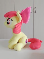 Size: 768x1024 | Tagged: safe, artist:nekokevin, imported from derpibooru, apple bloom, earth pony, pony, bow, female, filly, hair bow, irl, photo, plushie, side view, sitting, smiling, solo